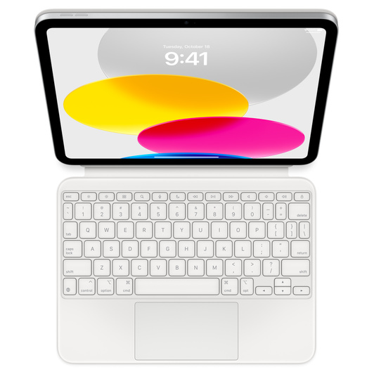 Vue plongeante montrant un iPad connecté à un Magic Keyboard Folio posé à plat. Écran affichant des graphismes circulaires colorés.