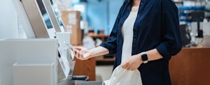 Woman pays for items using her phone.