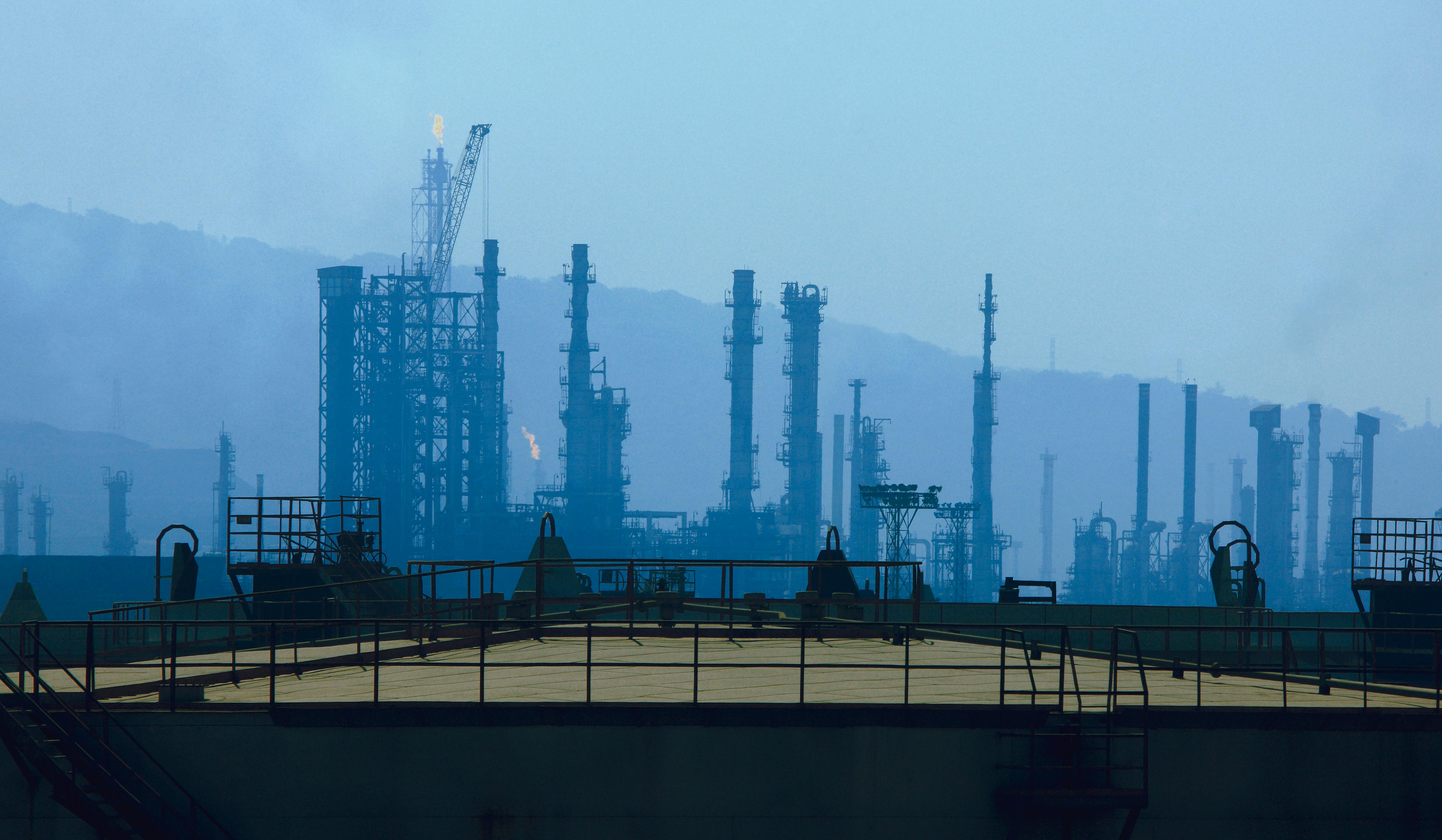 Photo depicts Mumbai,Maharashtra,India,March, 03,2009: Silhouette showing cluster of tall chimneys,columns,towers,flare stacks, storage tanks,of petroleum