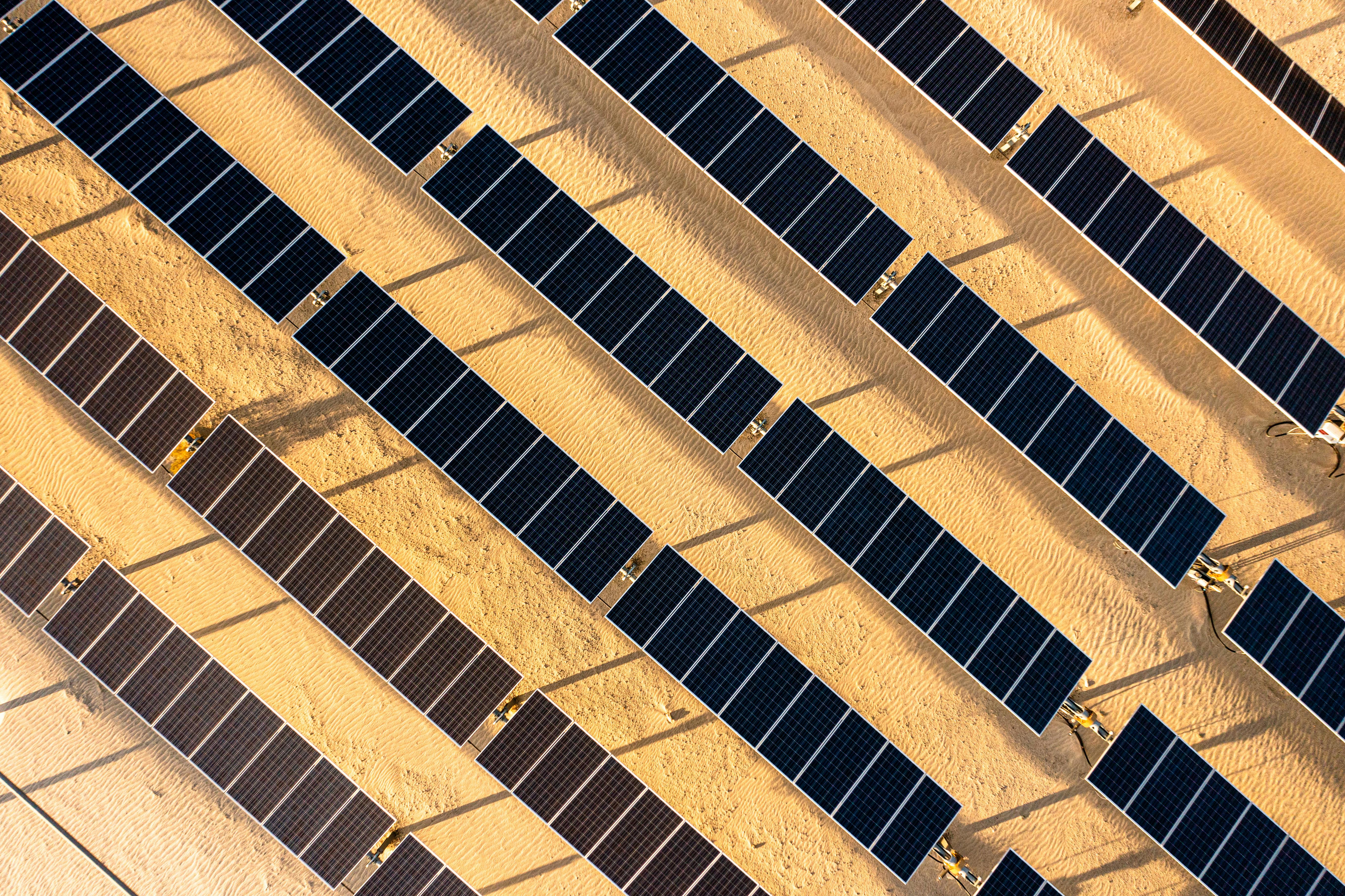 Photo depicts aerial Sunrise View over Solar Panels in Palm Springs California