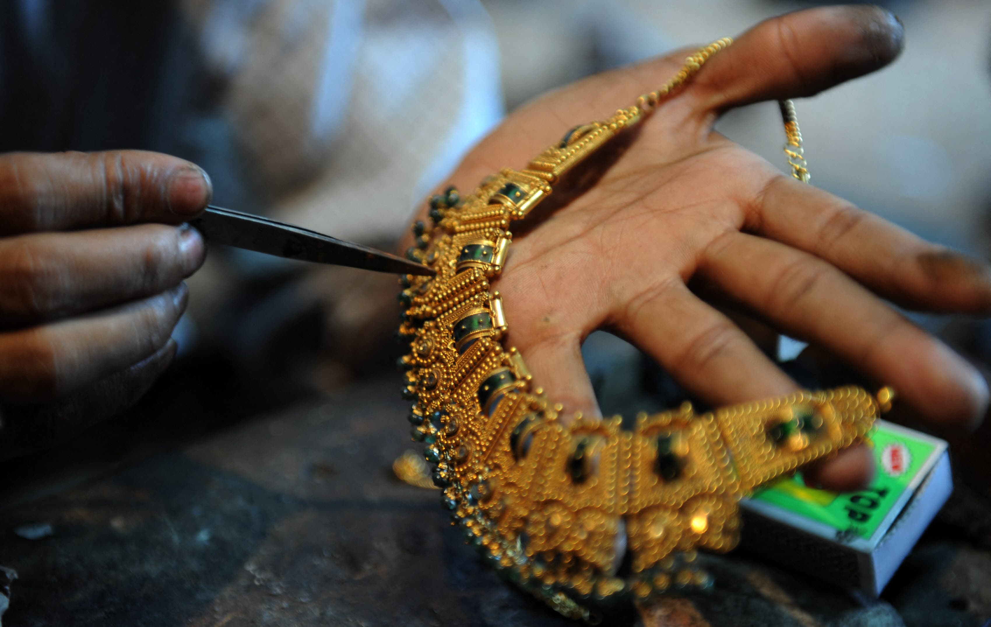 <p>An Indian goldsmith works on jewellery at a workshop in Siliguri</p>