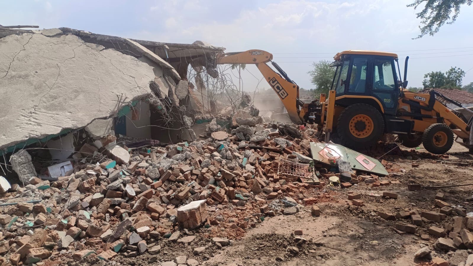 <p>Photos shared by Madhya Pradesh police show the homes being razed</p>