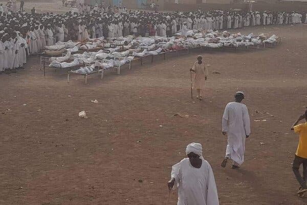 The bodies of close to 50 people are laid out for burial in Wad al-Noura, Sudan, on Wednesday after Rapid Support Forces attacked the village in Jazeera Province.