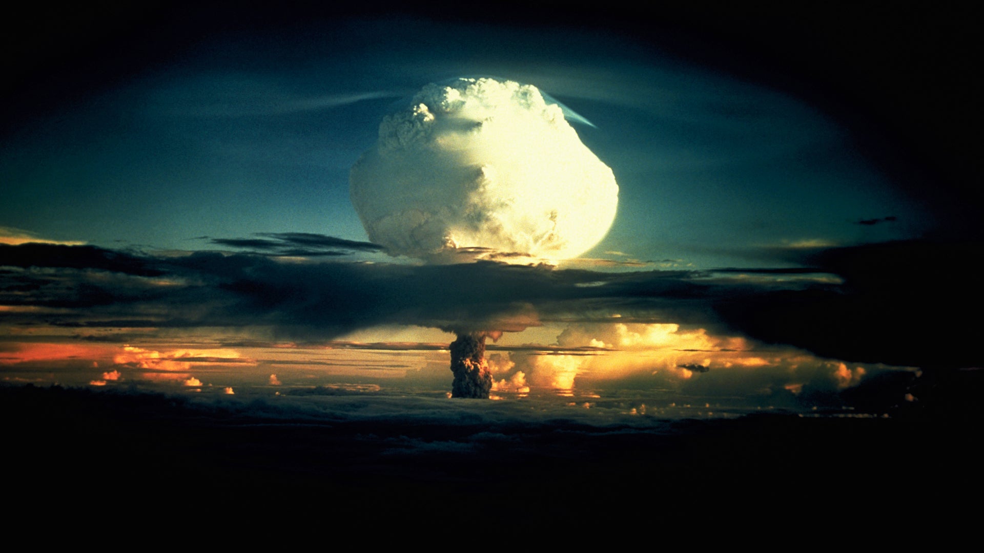 Operation Ivy Hydrogen Bomb Test in Marshall Islands A billowing white mushroom cloud, mottled with orange, pushes through a layer of clouds during Operation Ivy, the first test of a hydrogen bomb, at Enewetak Atoll in the Marshall Islands. (Photo by © CORBIS/Corbis via Getty Images)