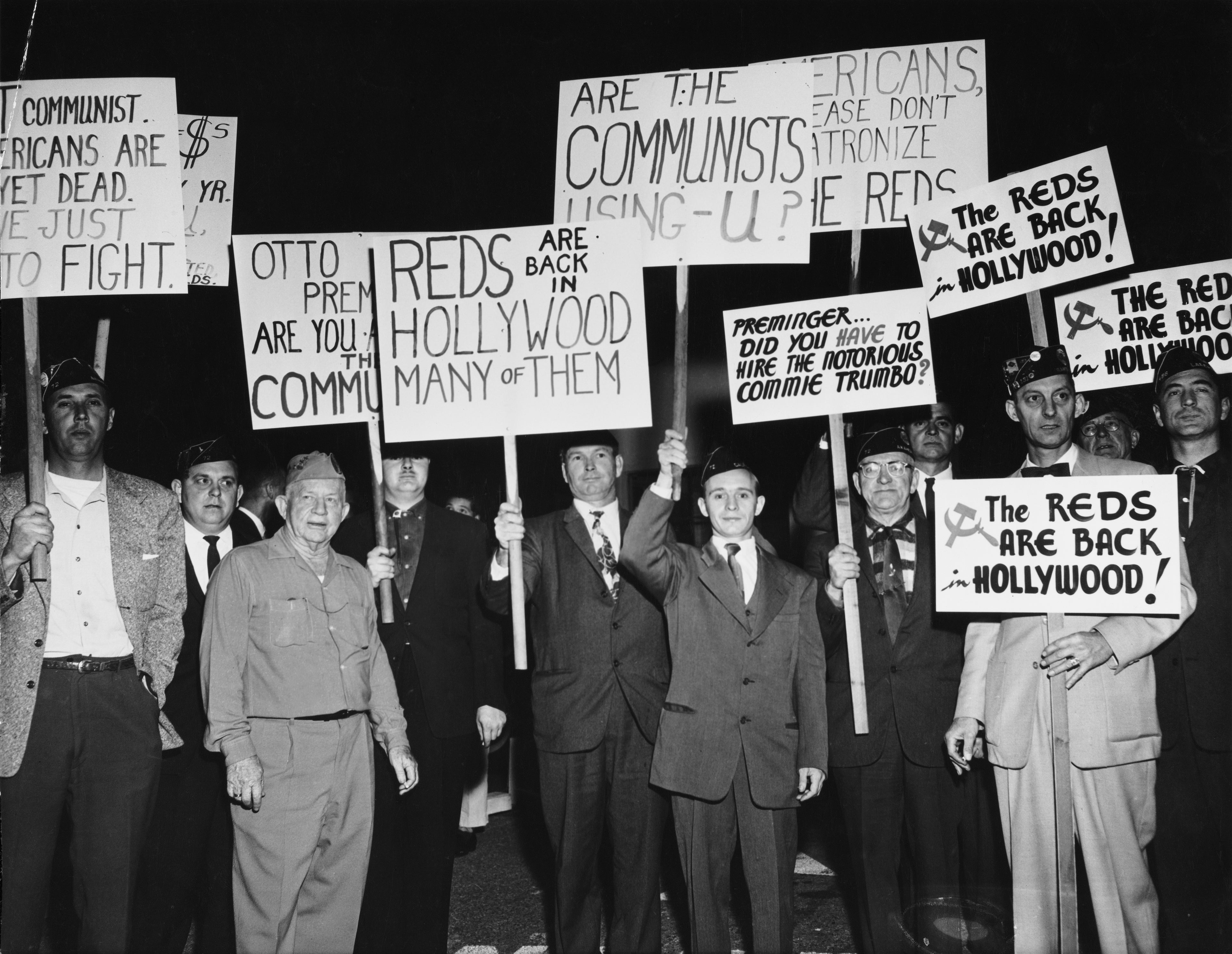 A group of protesters demonstrate holding placards against Communist sympathizers outside the Fox Wilshire Theatre in occasion of the premiere of film 'Exodus', which marked the end of the 'Hollywood Blacklist' when screen player Dalton Trumbo, a Communist Party member from 1943 to 1948 and member of the Hollywood Ten, was credited as the screenwriter of the film, Beverly Hills, Los Angeles, California, US, December 1960. (Photo by American Stock Archive/Archive Photos/Getty Images)