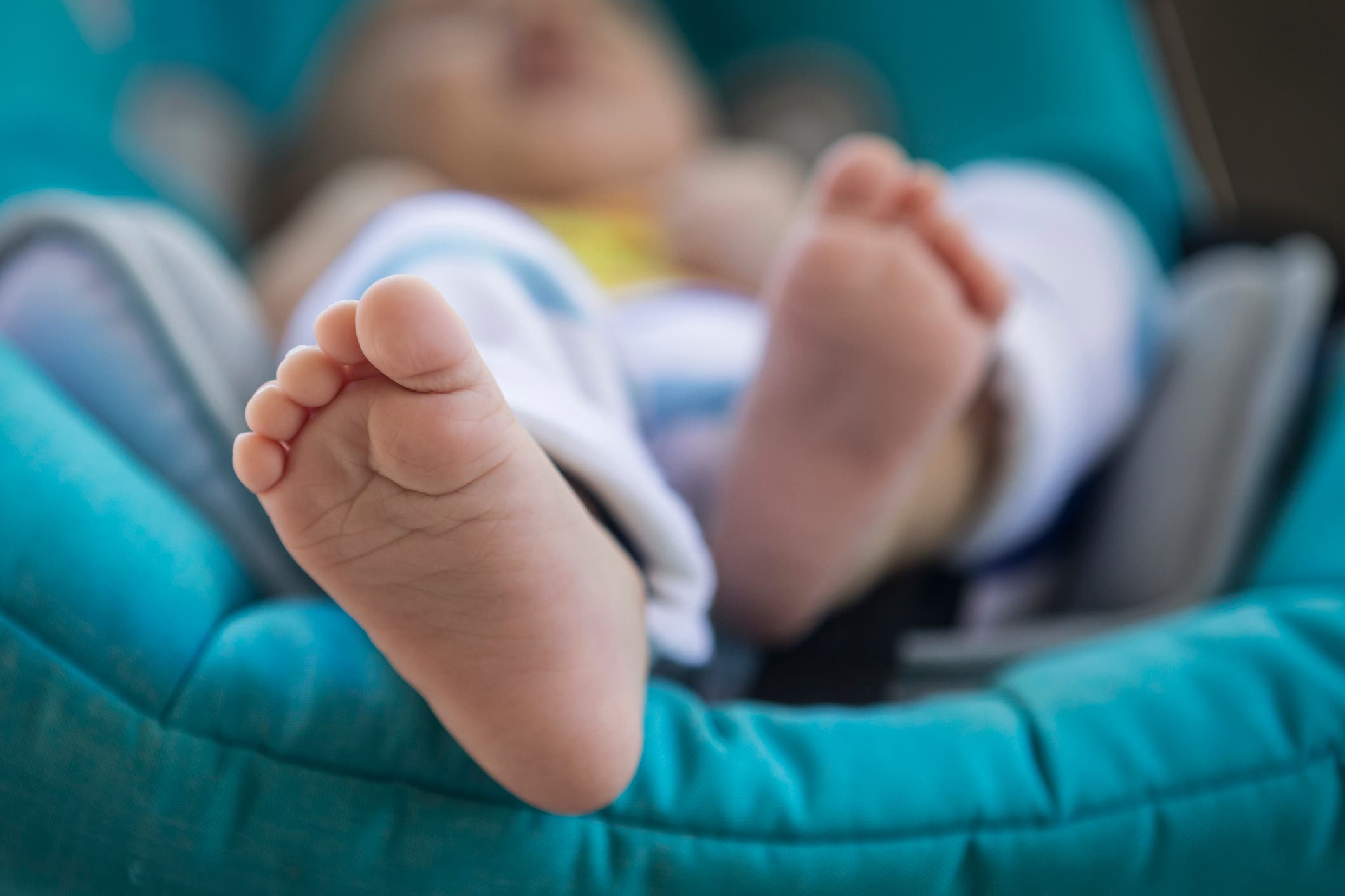 <p>File: A 2-month old baby boy of Asian and Caucasian origin having a nap in his blue stroller </p>