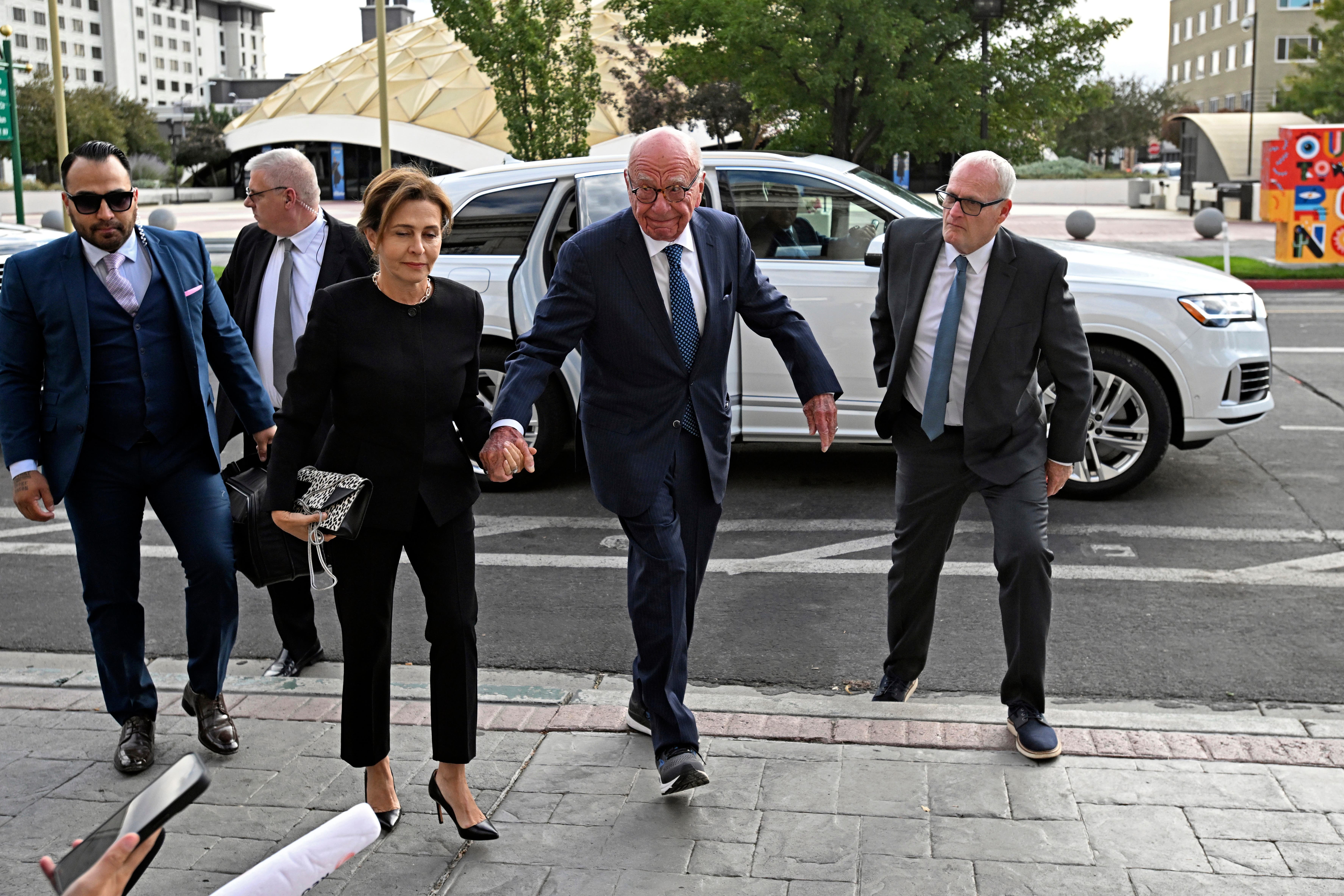 <p>Rupert Murdoch, center, and his wife Elena Zhukova Murdoch arrive at the Second Judicial District Court in Reno,</p>