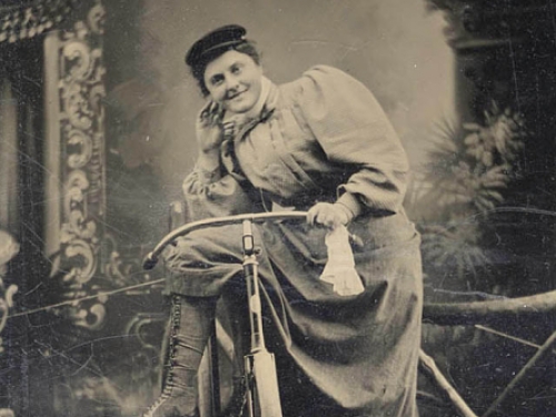 woman in a dress on a bicycle.