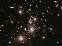 Galaxy clusters like Abell 2744 can act as a natural cosmic lens, magnifying light from more distant, background objects through gravity. NASA's James Webb Space Telescope may be able to detect light from the first stars in the universe if they are gravitationally lensed by such clusters. (astronomy, space exploration, galaxies)
