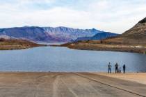 Visitors stand at the shoreline on Jan. 19, 2024, as water is flowing again into Boulder Harbor ...