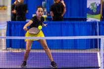 Daniela Filippini returns a serve while playing on one of the temporary courts used to try out ...