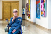 Dr. Robert Belliveau among his wife's works on display at the Rita Deanin Abbey Art Museum on T ...