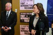 FILE - Minnesota Governor Tim Walz listens to Vice President Kamala Harris speak at Planned Par ...