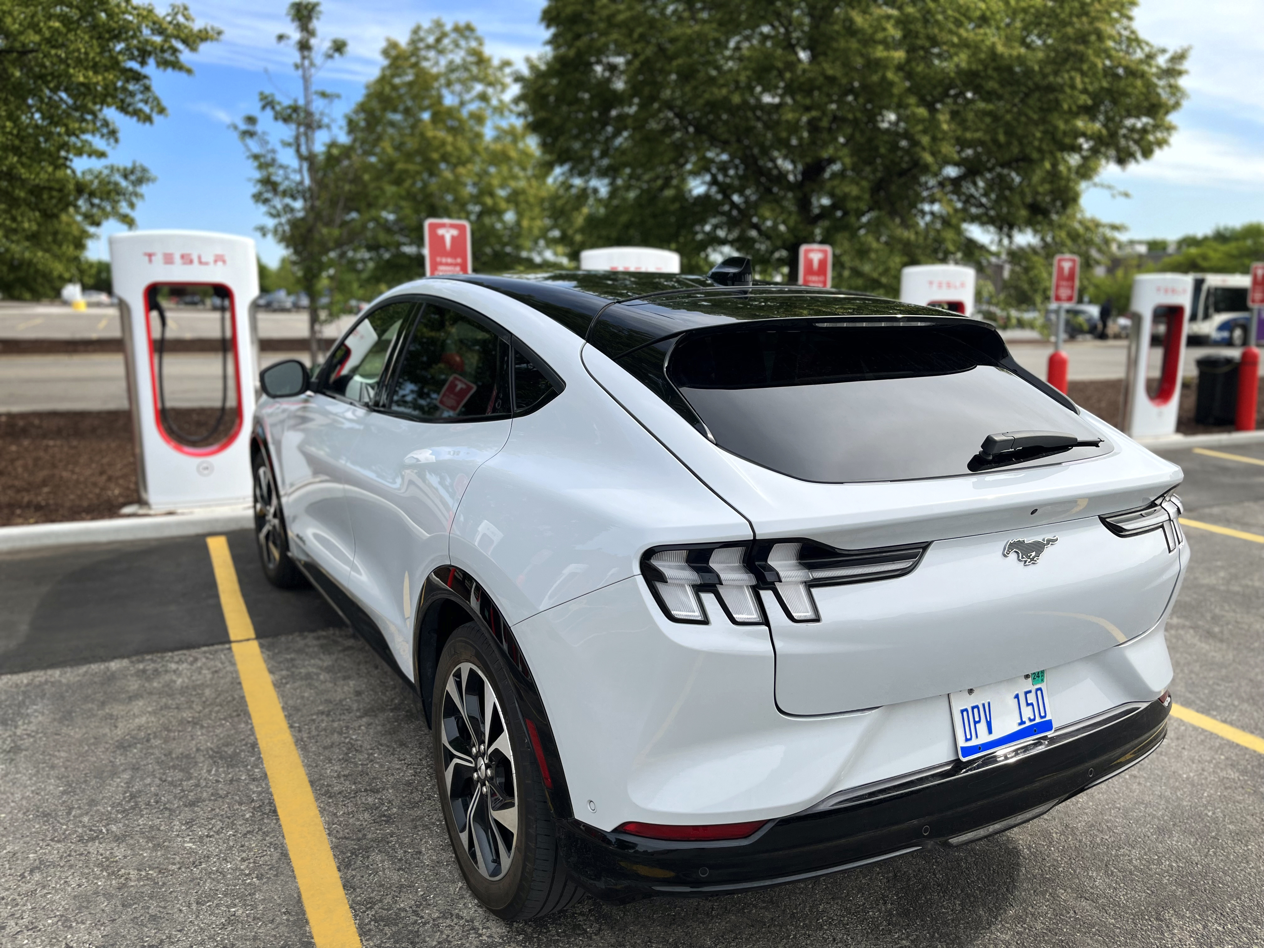 Ford EV charging at a Tesla Supercharger