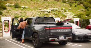 Rivian R1T at a Tesla Supercharger station