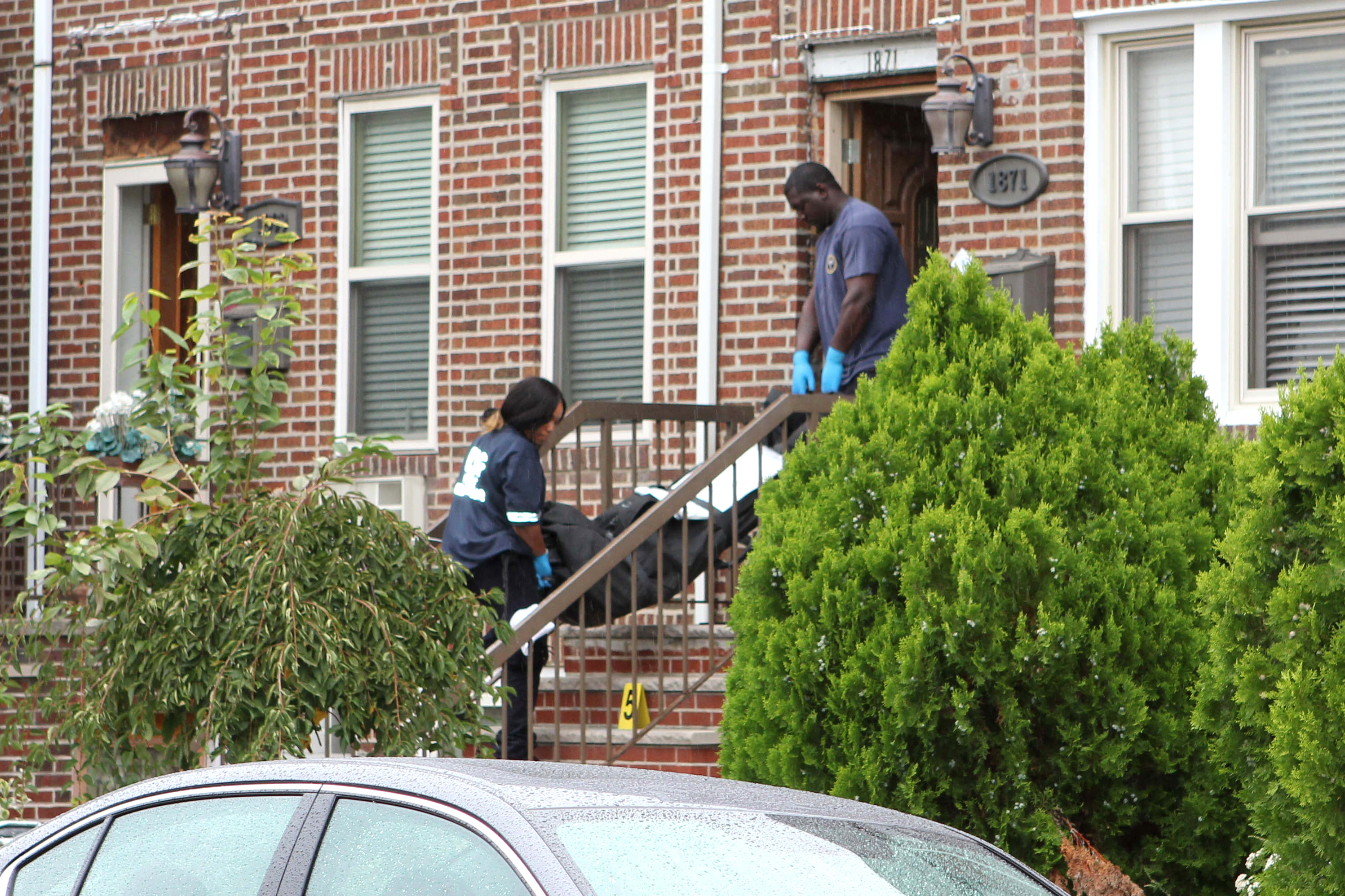 Officials remove the body of a 44-year-old man from the scene in Brooklyn.