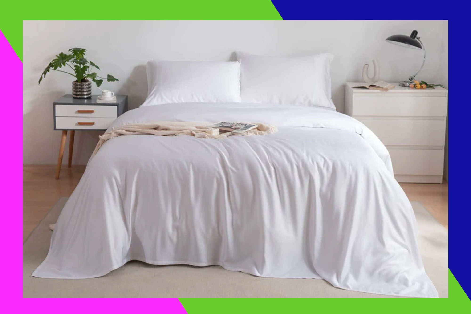 A bed with white sheets and pillows