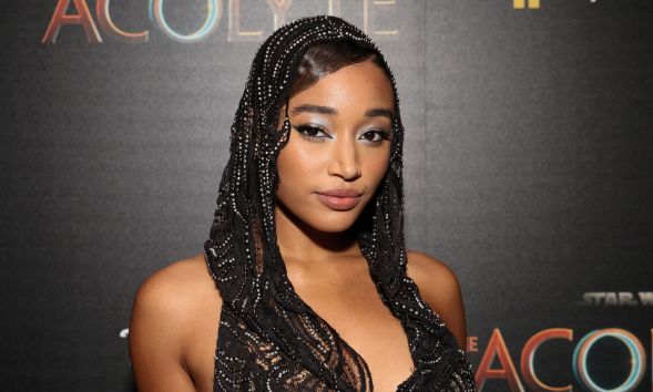 Amandla Stenberg wears a black lacy head covering while on the red carpet premiere of Star Wars: The Acolyte.