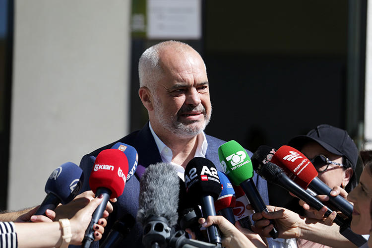 Albania's Prime Minister Edi Rama speaks to the media outside a polling station near Tirana on June 30. A press freedom mission raised several issues with Rama last month, including unresolved attacks on journalists and draconian laws. (Reuters/Florion Goga)