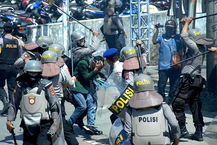 Police beat students in Makassar, Indonesia, on September 24, 2019. Several journalists were injured by police while covering the student protests. (Antara Foto/Abriawan Abhe via Reuters)