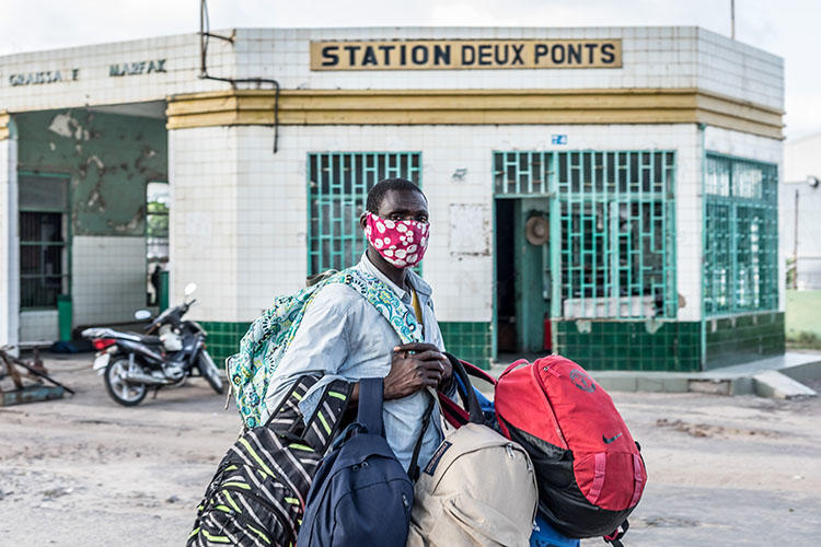 A vendor wears a mask as a preventive measure against the spread of the COVID-19 coronavirus in Cotonou on April 8, 2020. CPJ and partner organizations called for the release of Beninese journalist Ignace Sossou on appeal. (Yanick Folly/AFP)