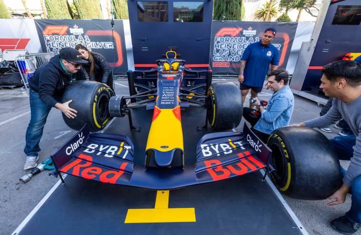 Angel Rodriguez, left, of Las Vegas, competes in a pit stop tire-changing race during the Formu ...