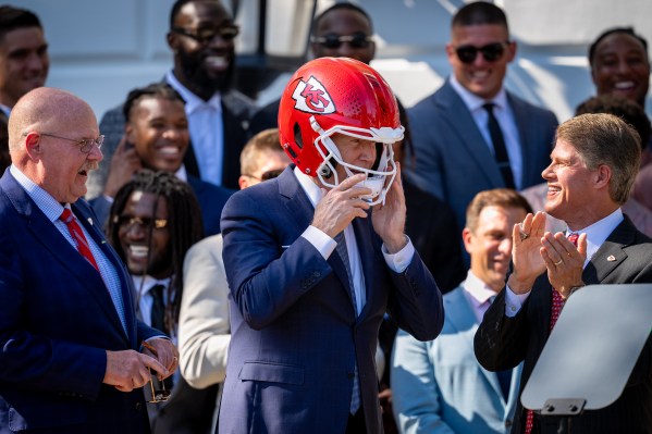 President Biden Hosts Super Bowl Champion Kansas City Chiefs At White House WASHINGTON, DC - MAY 31: Kansas City Chiefs coach Andy Reid (L) and CEO Clark Hunt (R) react as U.S. President Joe Biden puts on a team helmet presented to him during an event on the South Lawn of the White House on May 31, 2024 in Washington, DC. President Biden hosted the Chiefs to honor their 2024 Super Bowl win. (Photo by Andrew Harnik/Getty Images)