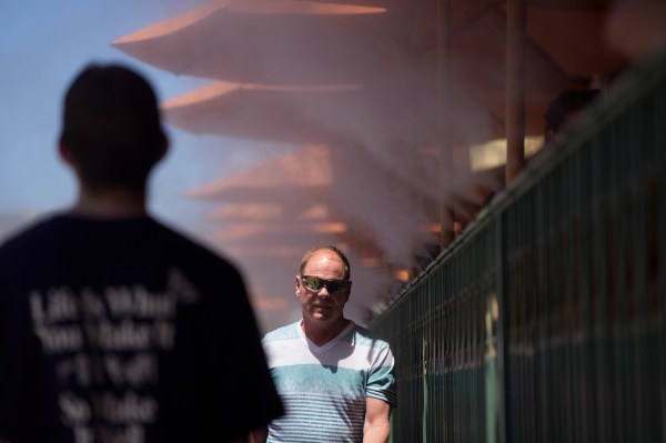 People walk through cooling misters along the Las Vegas Strip, Tuesday, June 4, 2024, in Las Vegas. Parts of California, Nevada and Arizona are expected to bake this week as the first heat wave of the season arrives with triple-digit temperatures. (AP Photo/John Locher)