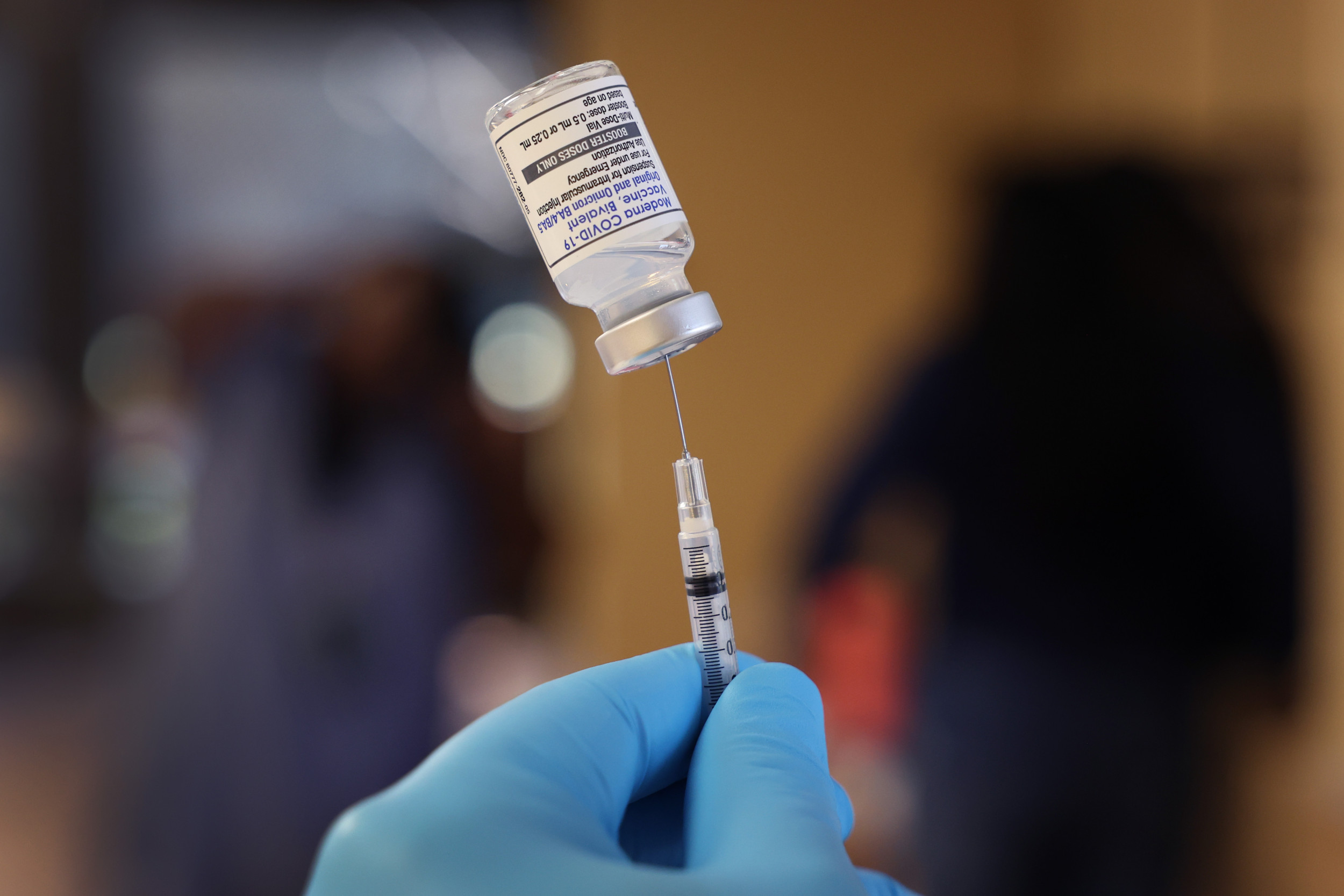 A pharmacist prepares to administer COVID-19 vaccine 