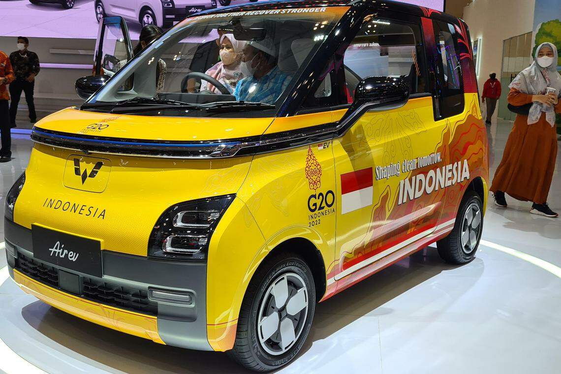 Visitors trying mini-electric car Wuling Air EV launched at Indonesia's largest auto show - Gaikindo Indonesia International Auto Show - that runs from Aug 11 to 21, 2022. Wuling Motors will produce 300 electric four-seaters to welcome delegates convening for the G20 Summit in Bali in November. 