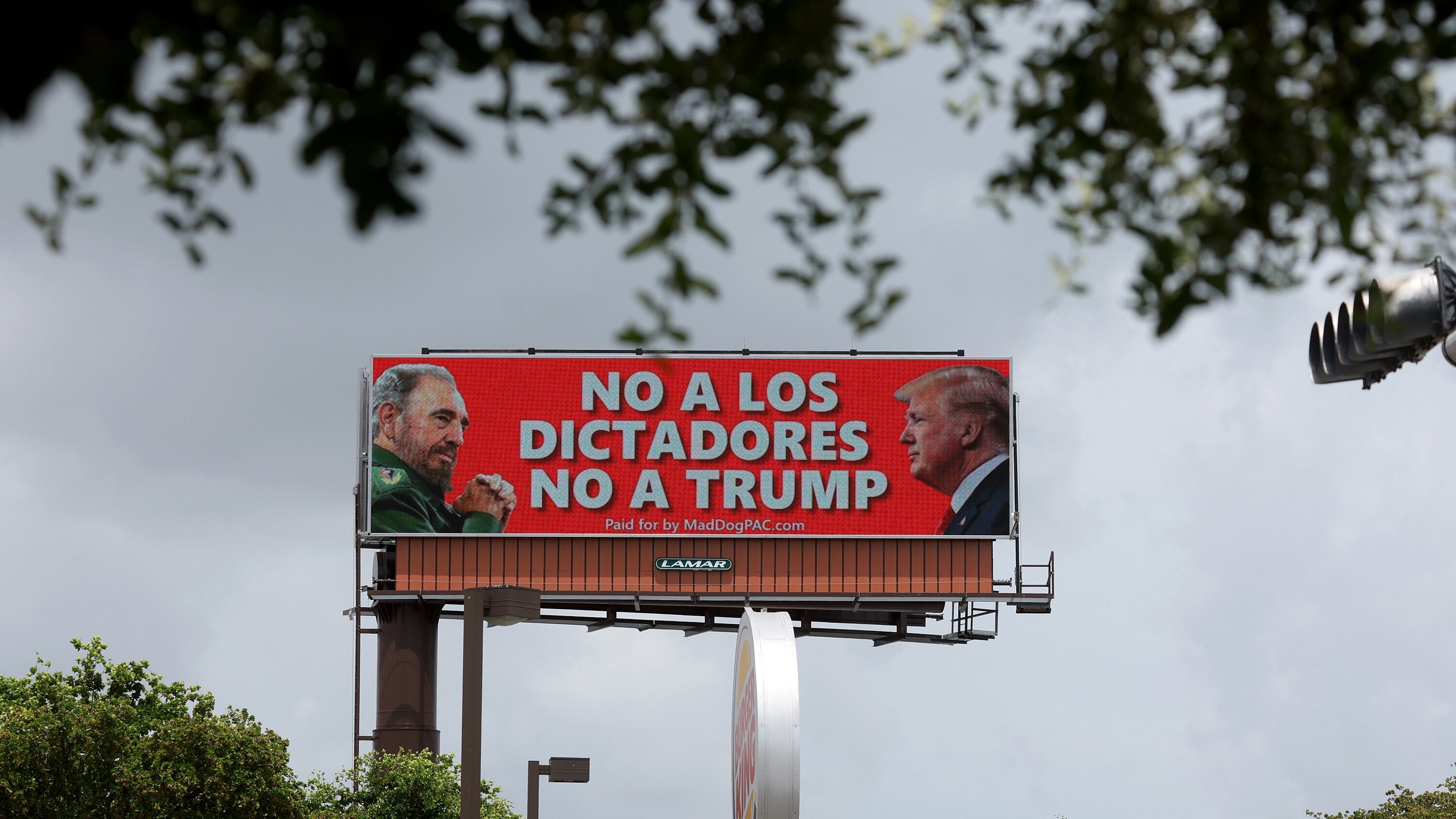 A poster comparing former U.S. President Donald Trump to the late Cuban leader Fidel Castro in Hialeah, Florida on June 19, 2024.