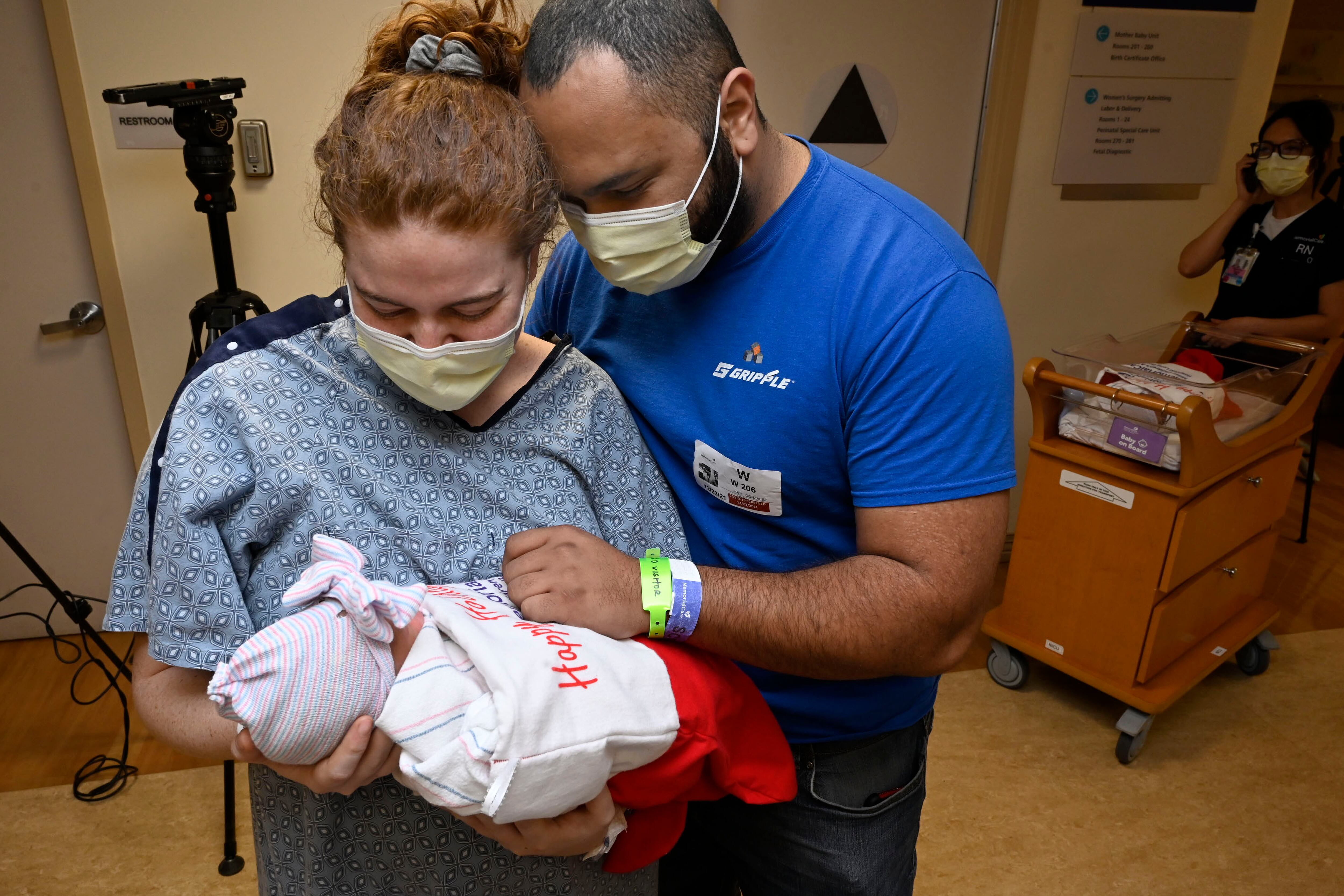 A couple holds their first child at a Long Beach hospital.