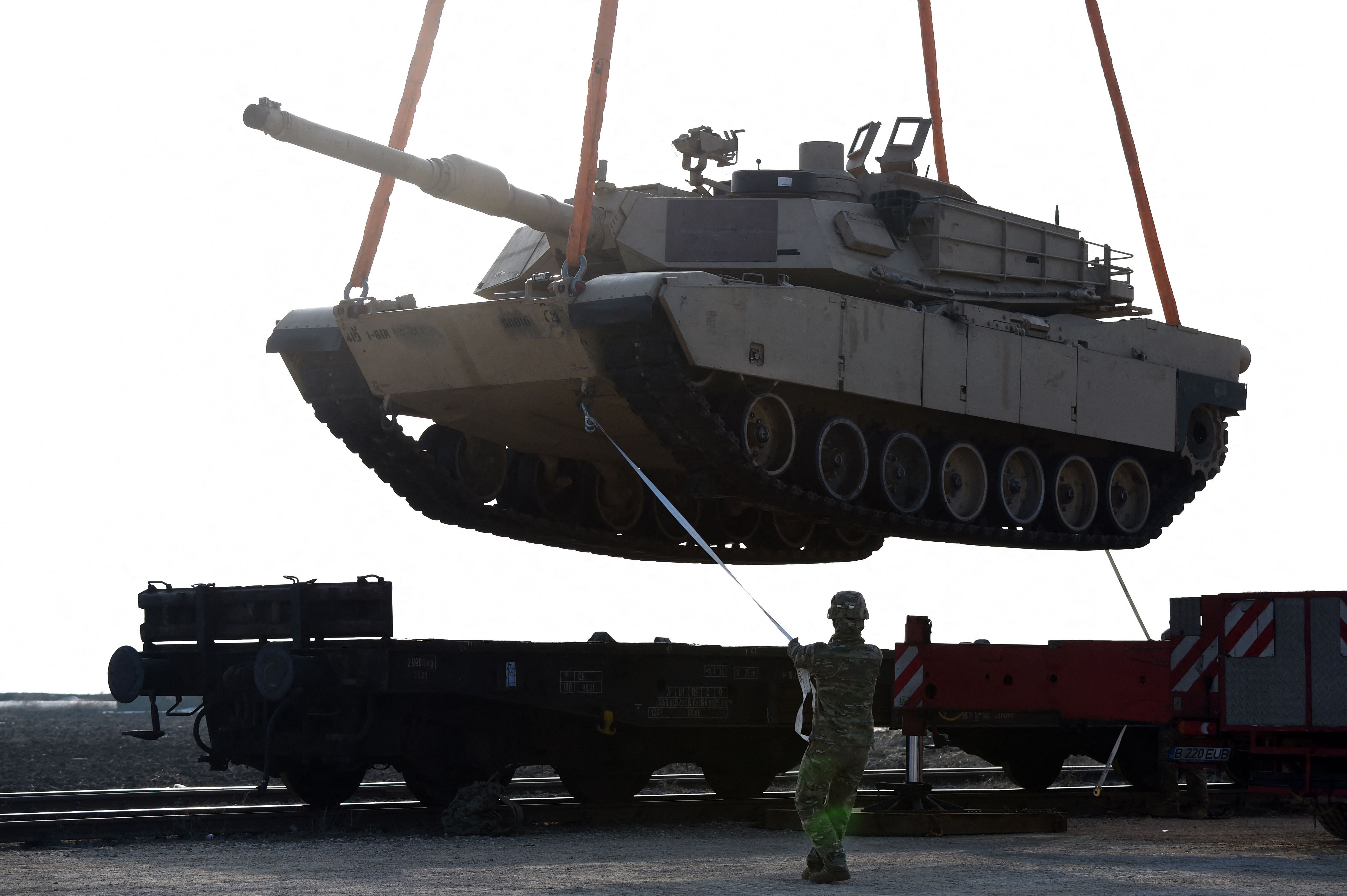 In this file photo taken on February 14, 2017, a US soldier helps to maneuver an Abrams tank.