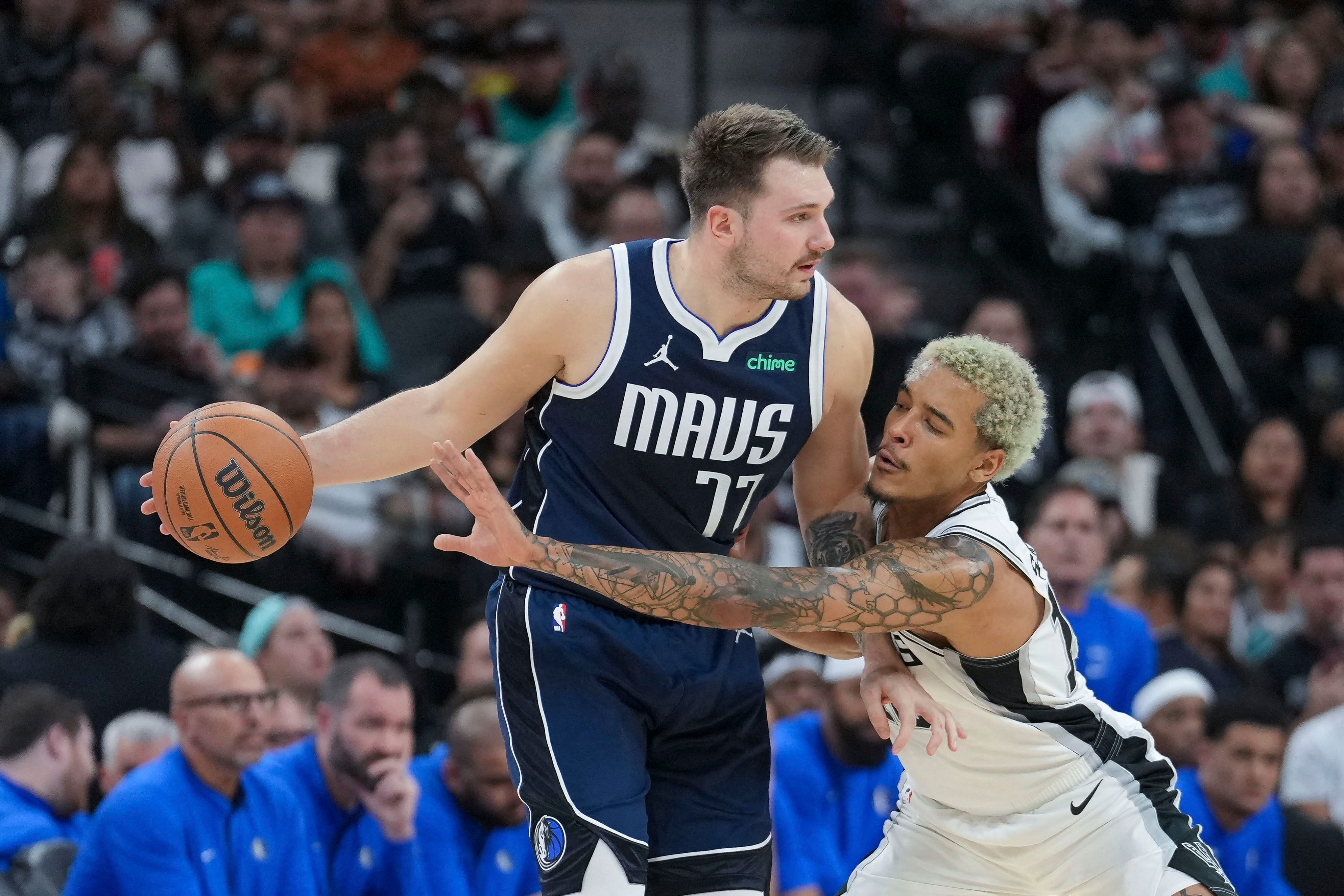 Jeremy Sochan of the San Antonio Spurs tries to grab the ball from Luka Dončić of the Dallas Mavericks in a game last week.