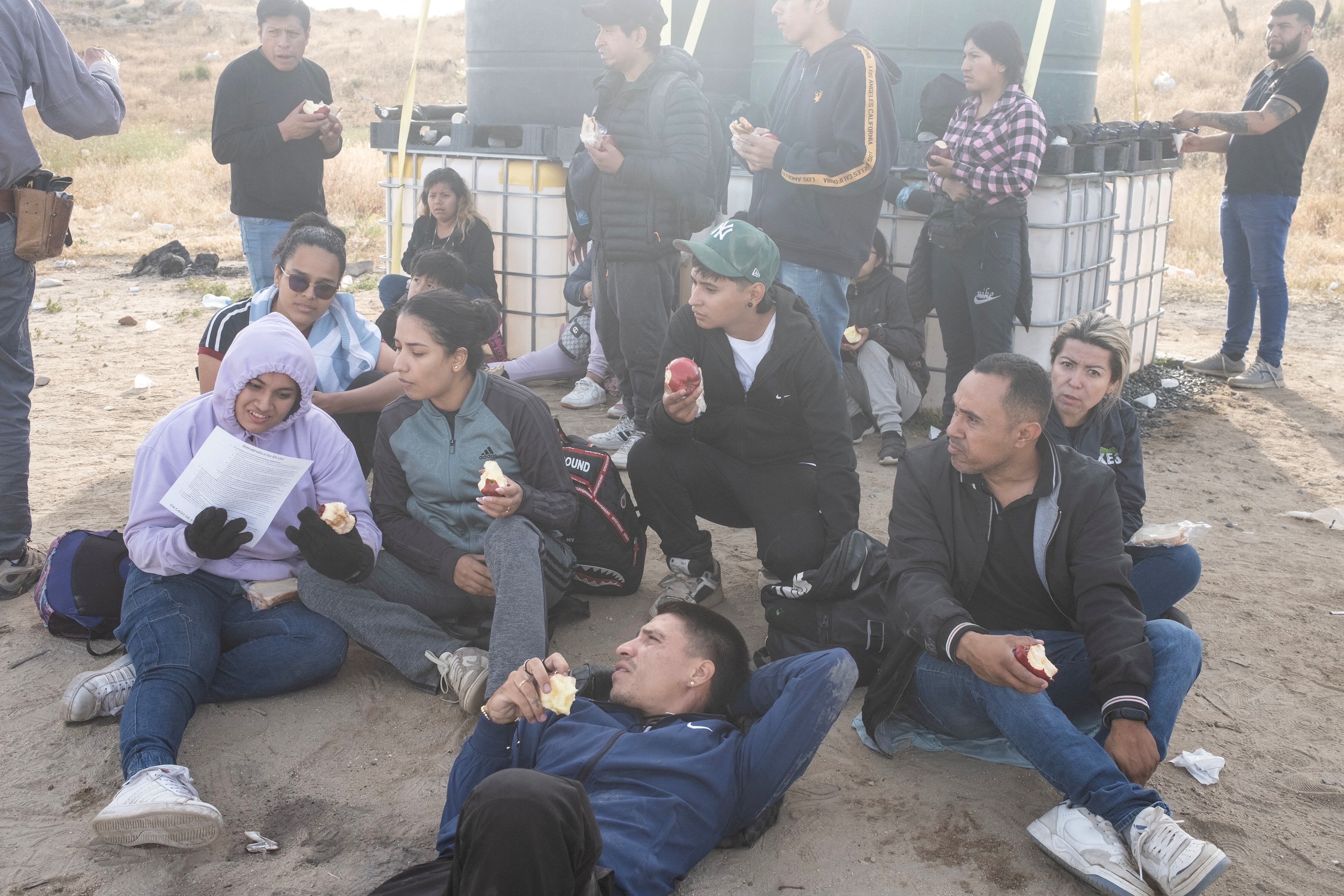 Migrants from Ecuador wait to be transported by the U.S. Border Patrol after crossing at Jacumba Spots, California, on June 4.