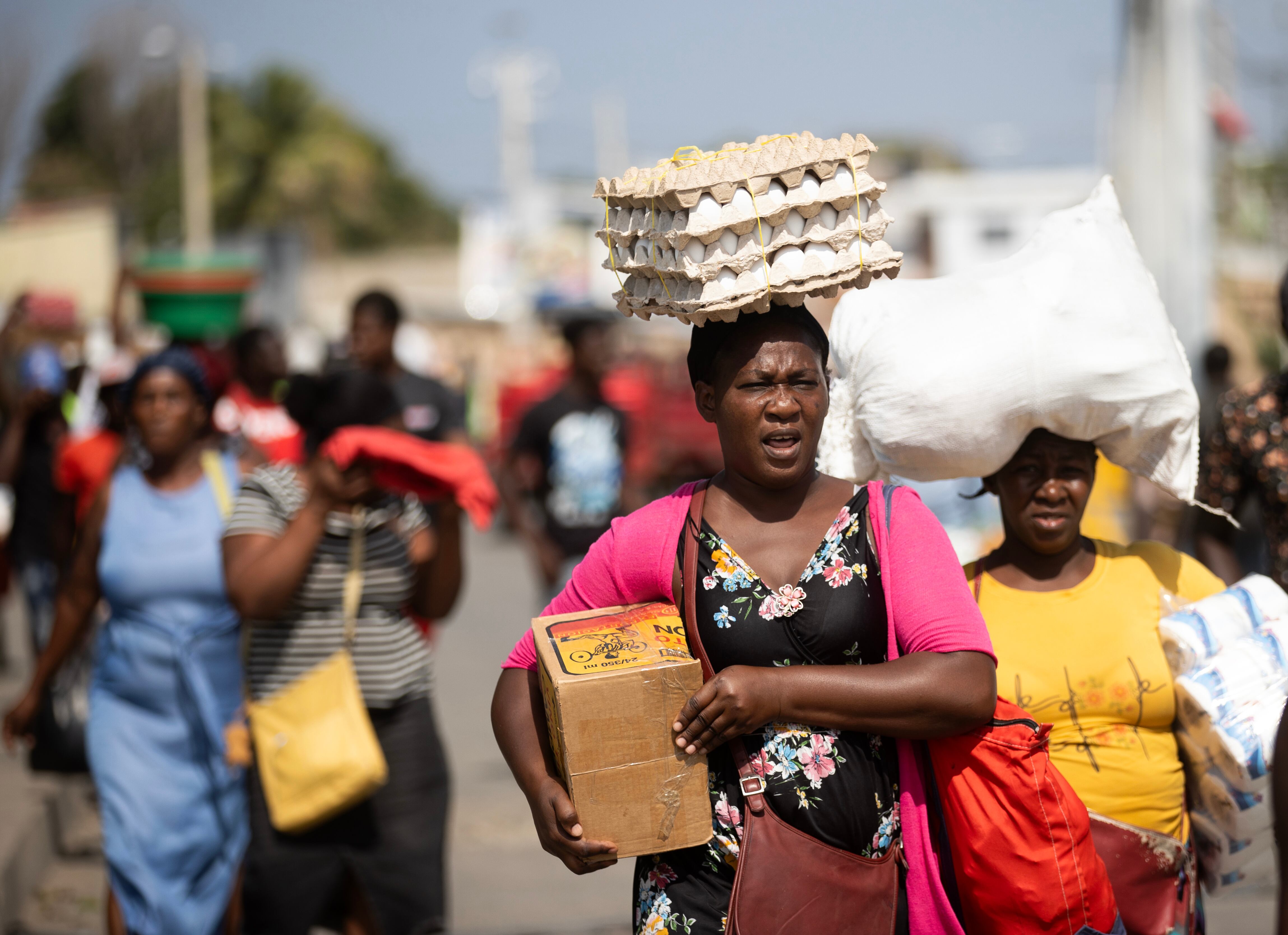 A group of women returns home after shopping on the border between Haiti and the Dominican Republic.