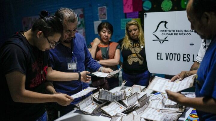 Electoral officials and poll watchers count votes after polls closed during general elections in Mexico City.