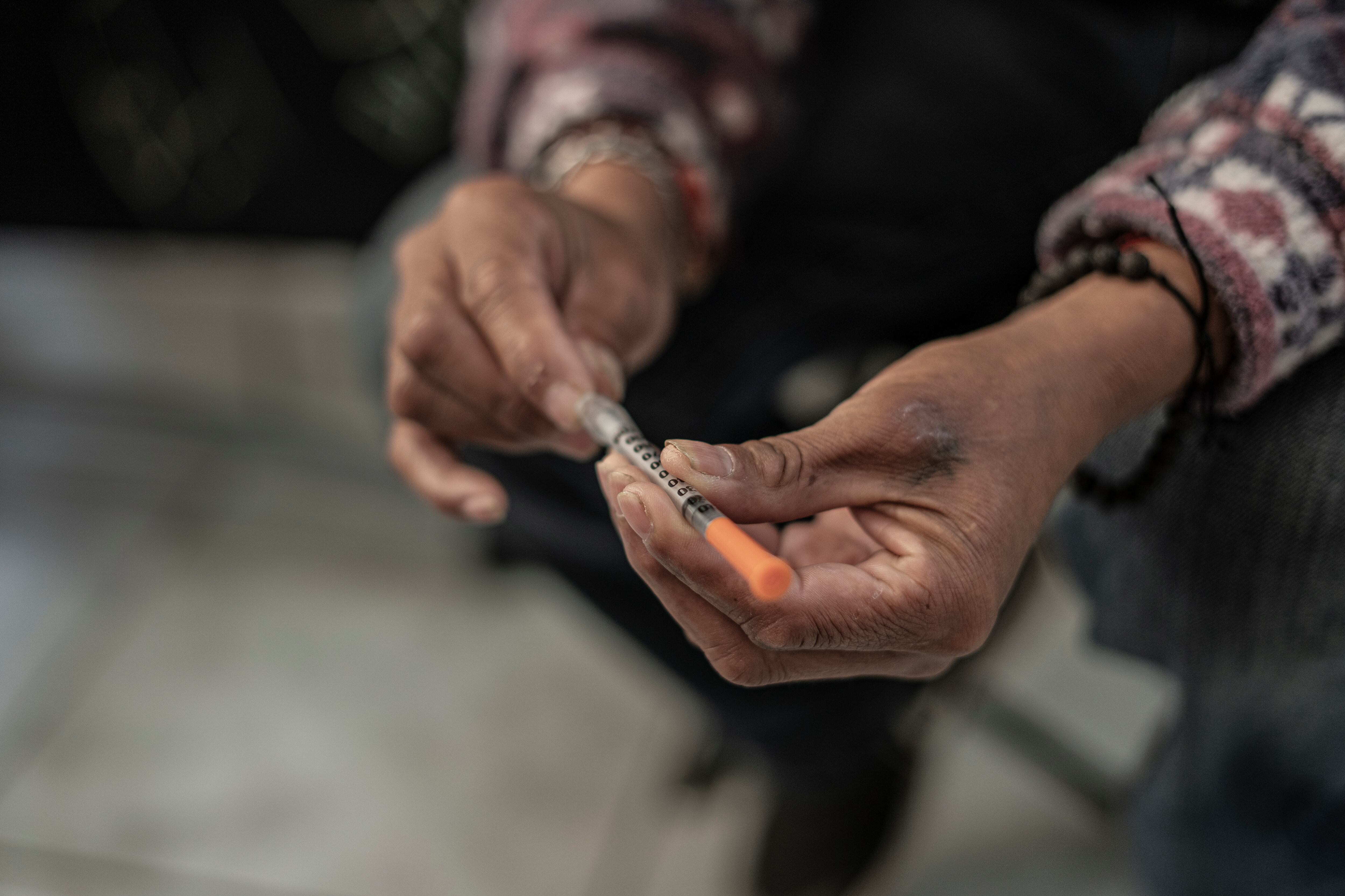 A woman shows a syringe used to inject fentanyl, in Tijuana (State of Baja California), in May 2023.