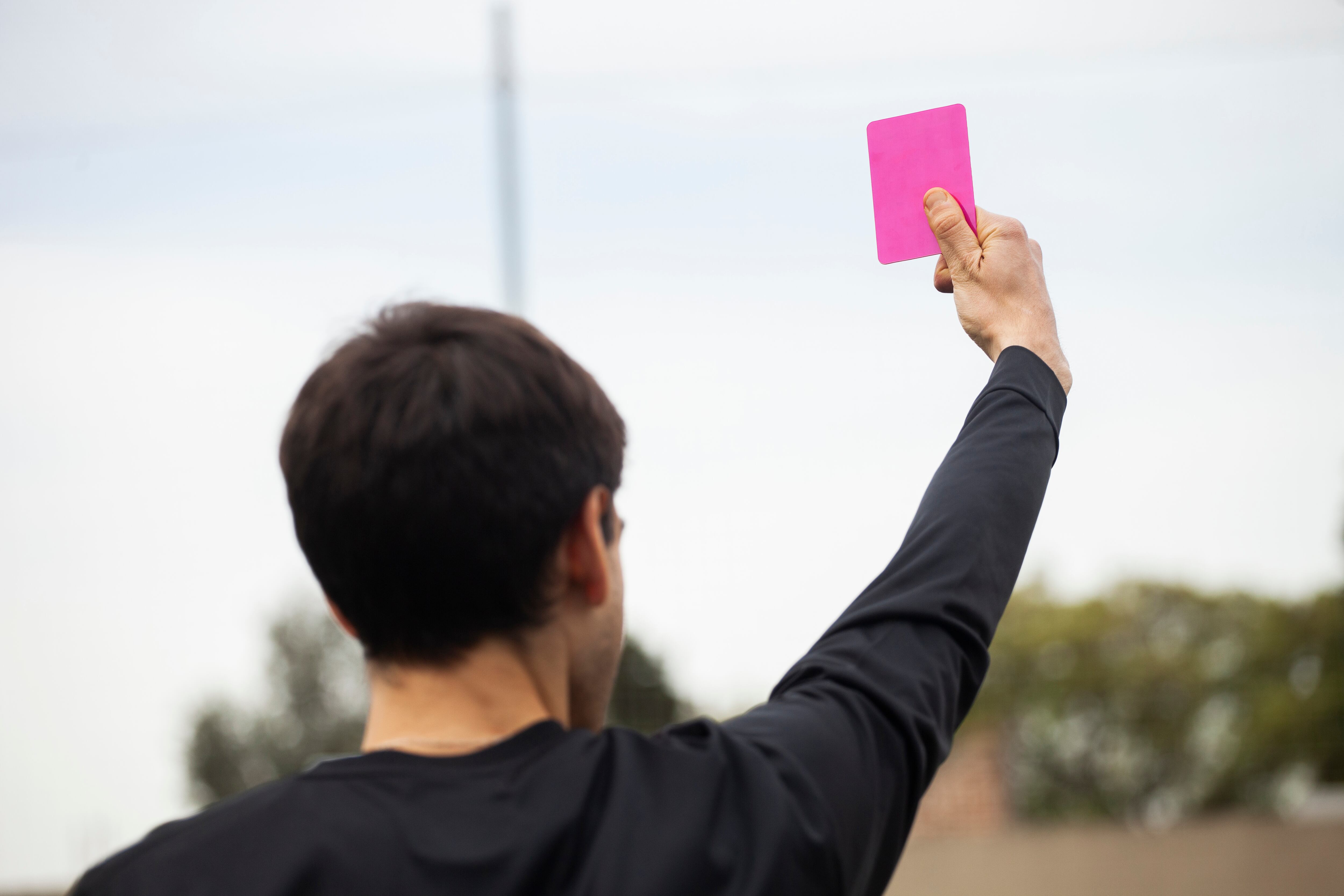 A member of the technical staff holds us a pink card.