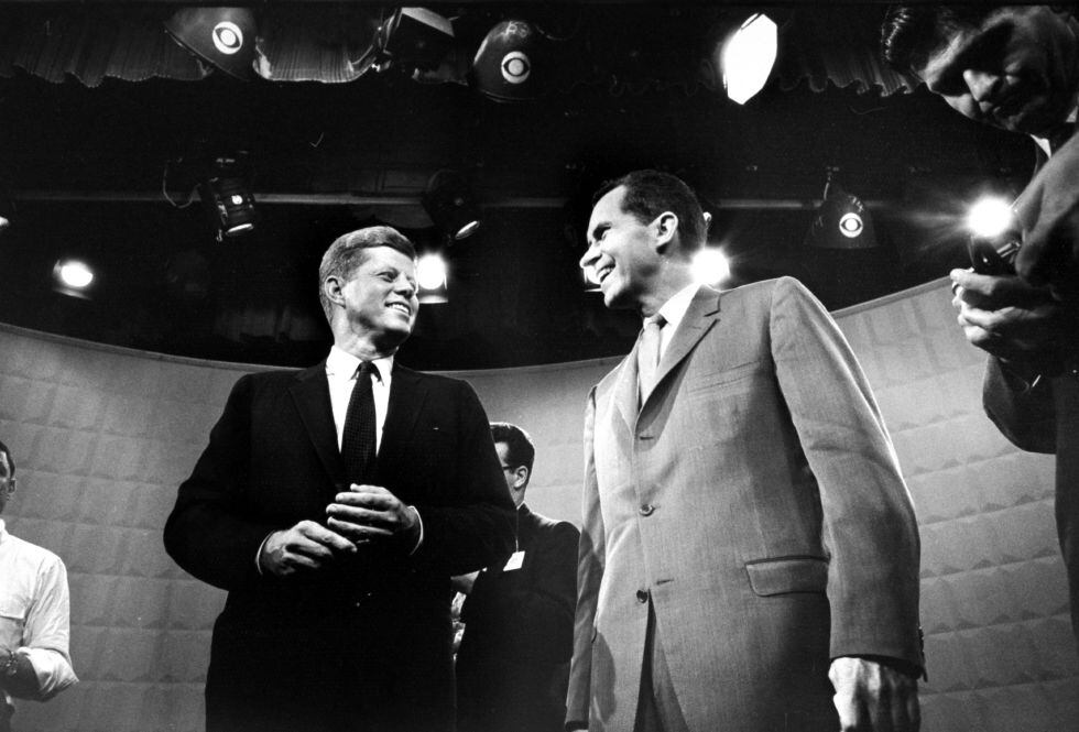 Richard Nixon (right) and John F. Kennedy, smiling moments before the start of the first televised election debate in history, in September 1960.