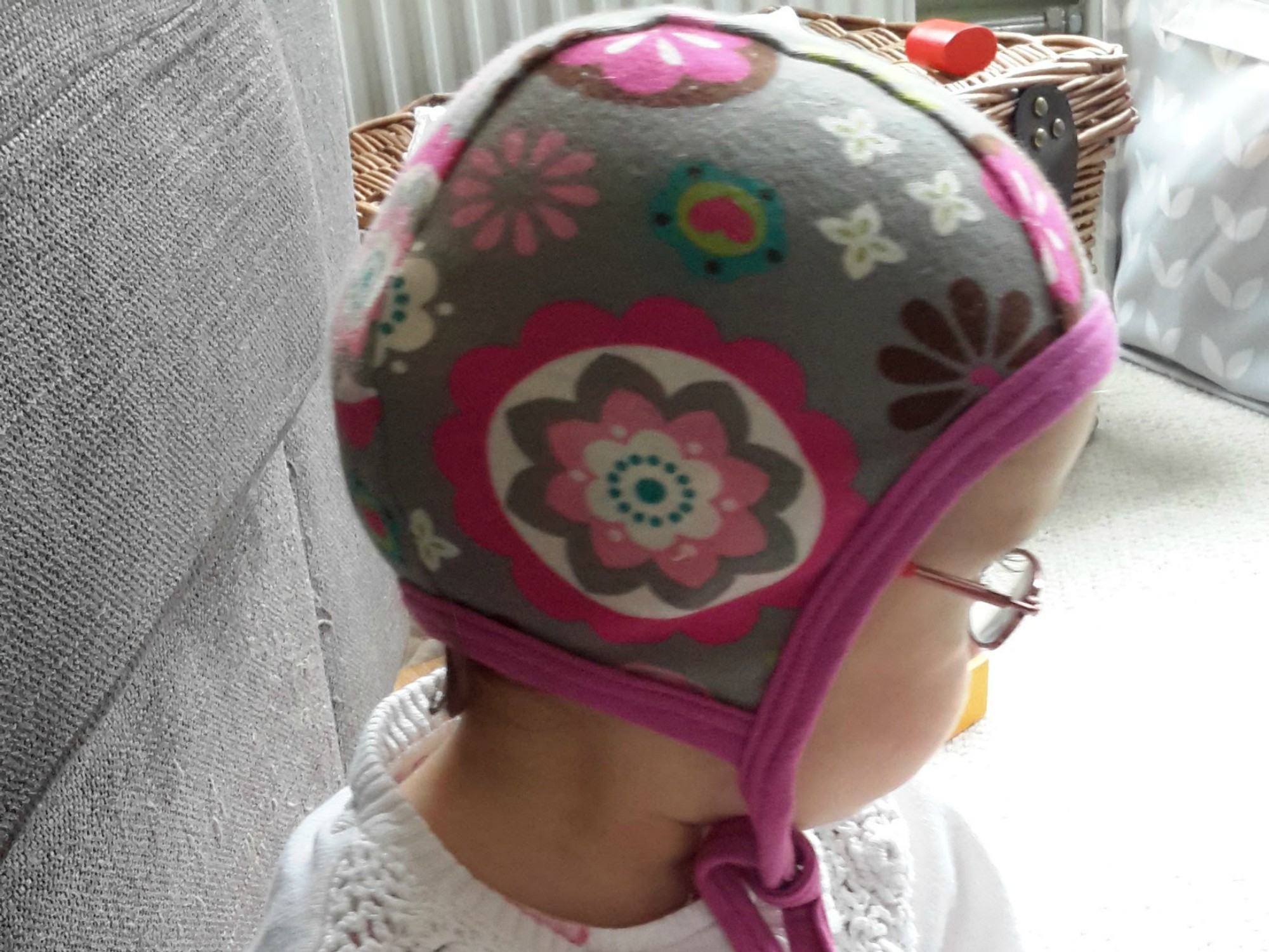 A young girl with a pilot hat on her head
