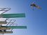 low angle view of a female swimmer preparing to dive from diving board against clear blue sky.