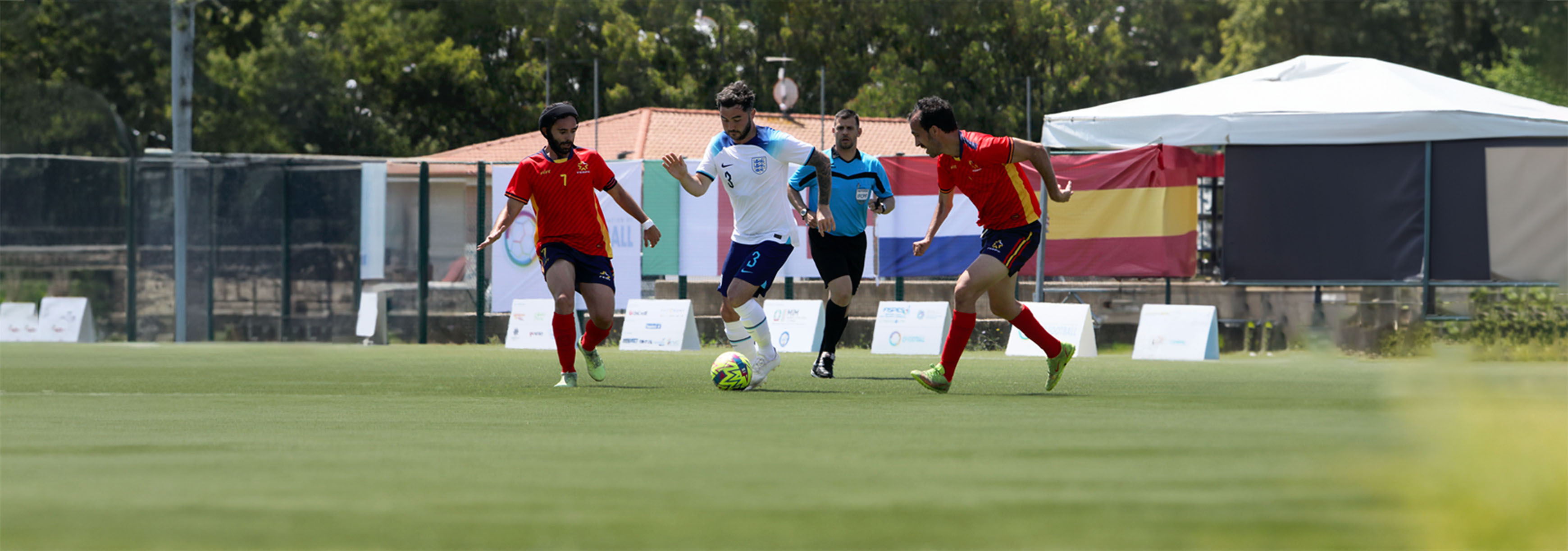 England CP's David Porcher runs with the ball between two defenders during the IFCPF European Championship match between England CP and Spain.