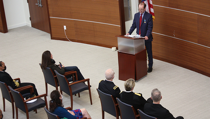 Dr. Louis French standing at podium