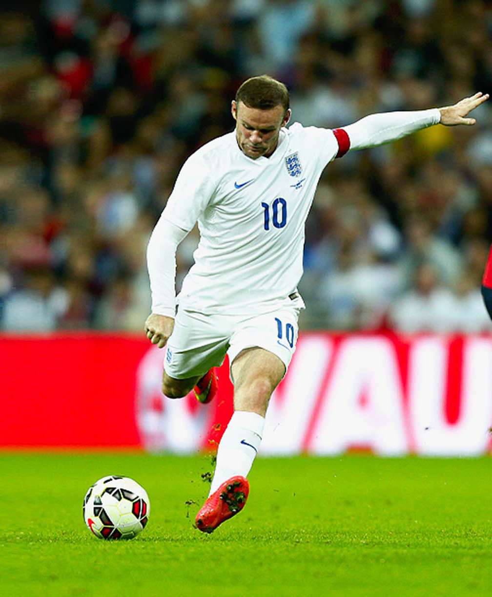 Wayne Rooney goes to kick the ball