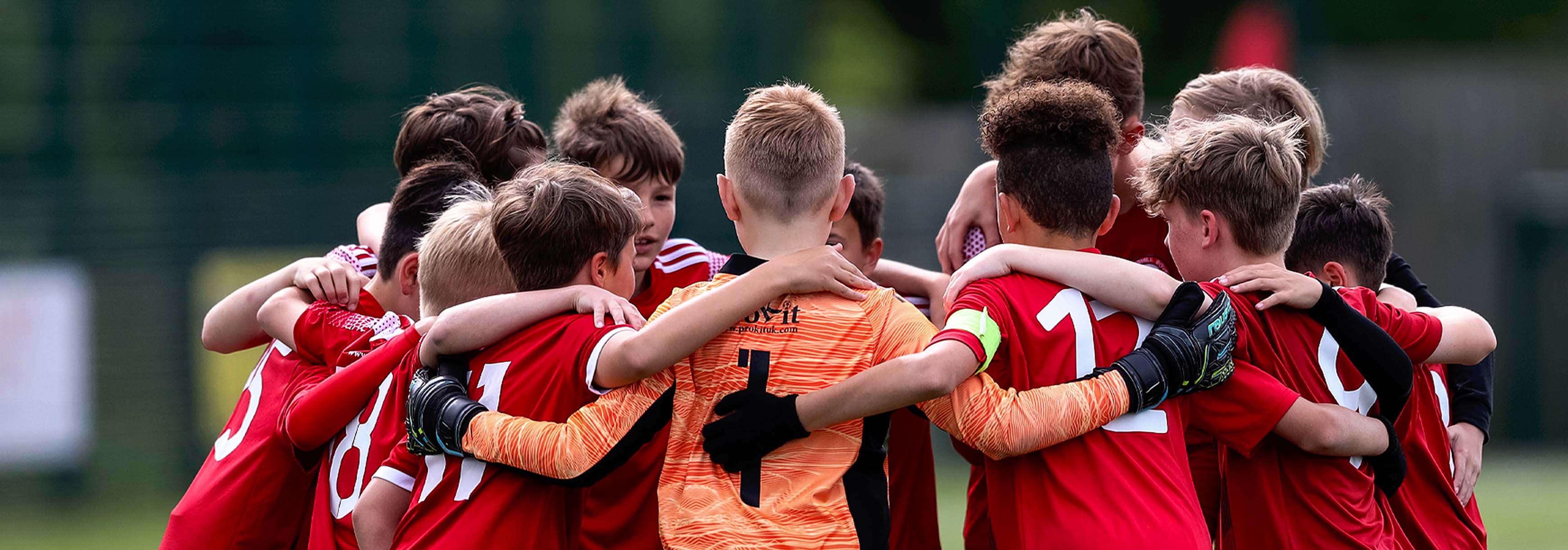 A group of young players huddle together