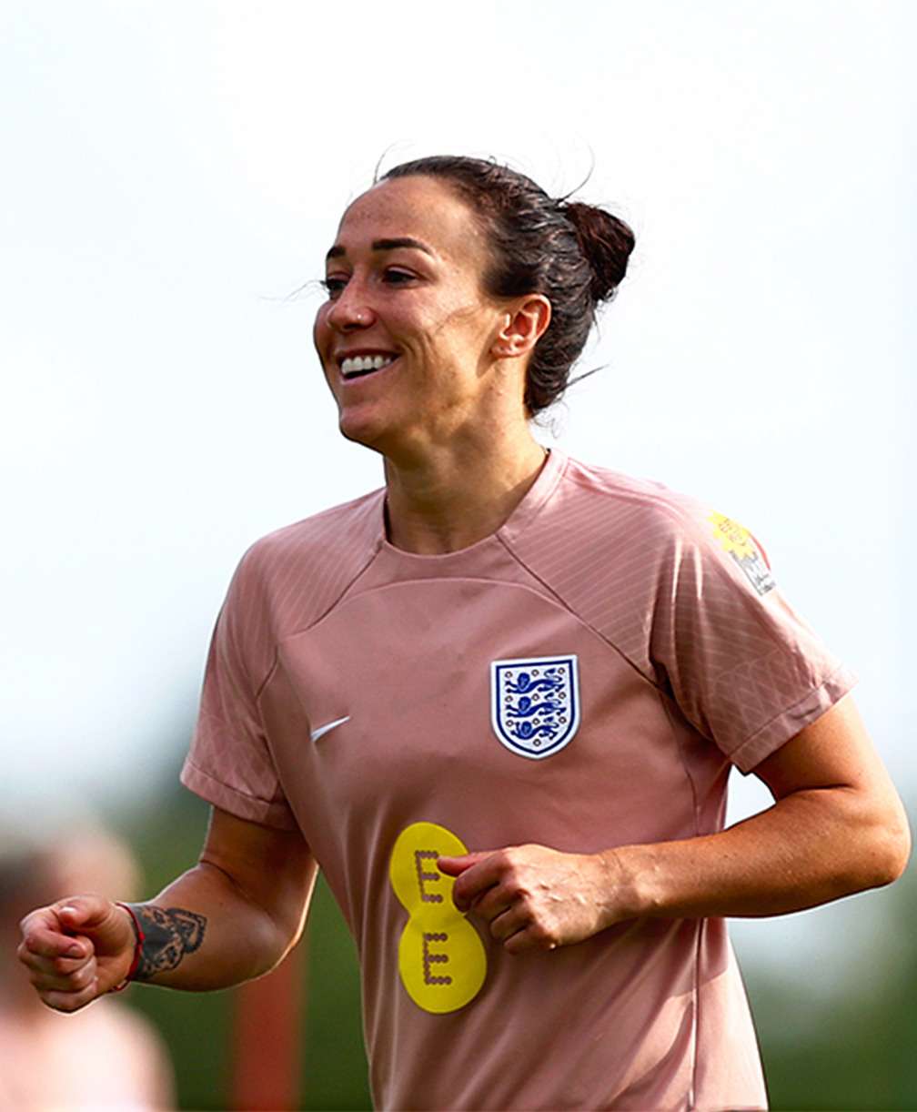 An upper body shot of Lucy Bronze smiling while running.