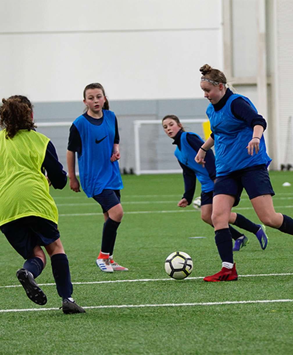A group of girls play football