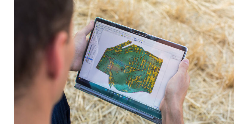 A man peers at a map on his tablet.