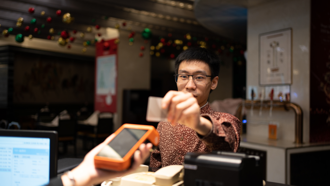 man paying with credit card